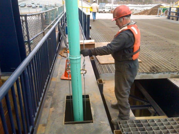 Worker pouring concrete with a SlikTremie.